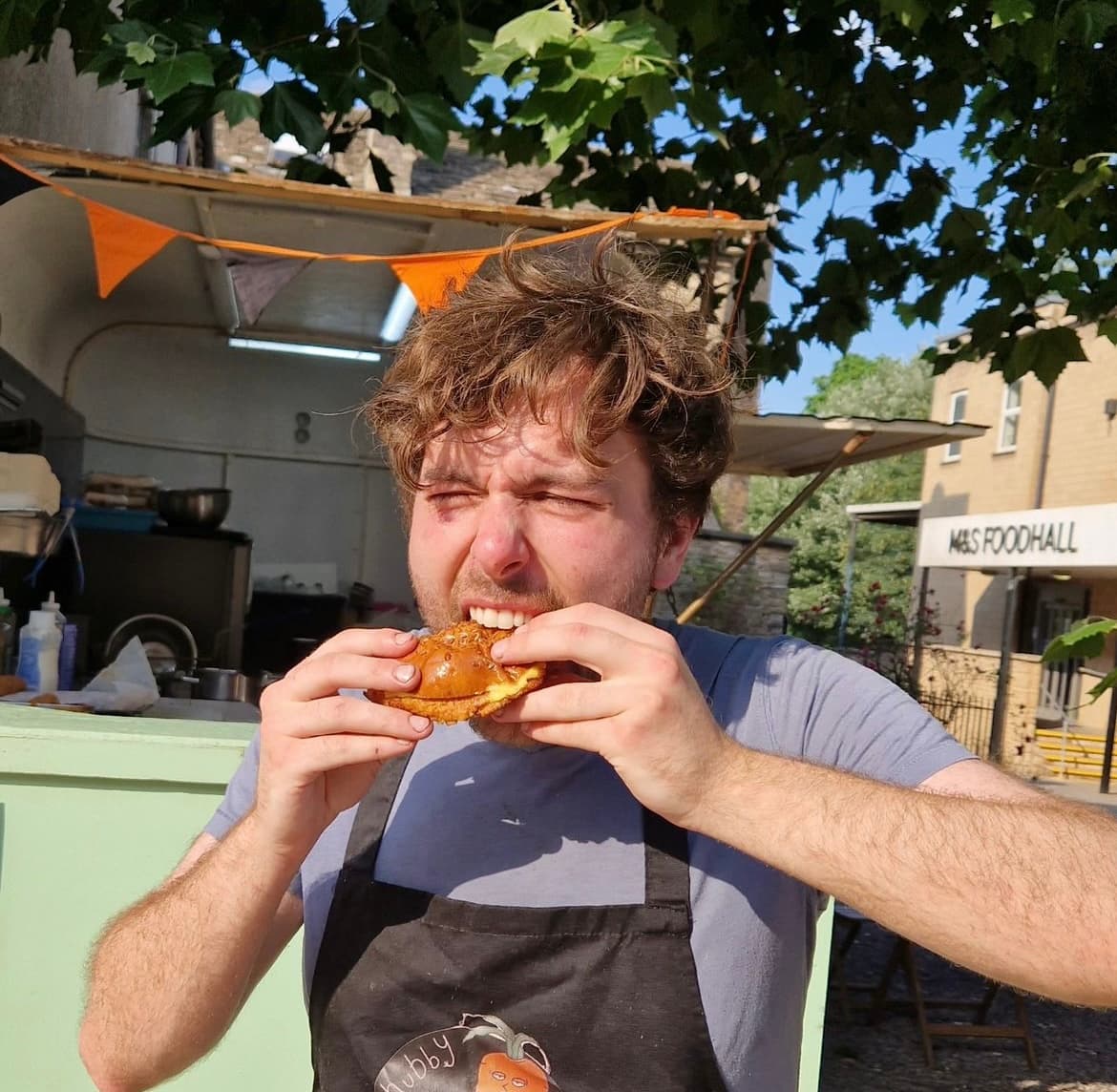 Louis from Chubby Vegans enjoying a burger on site in Frome.
